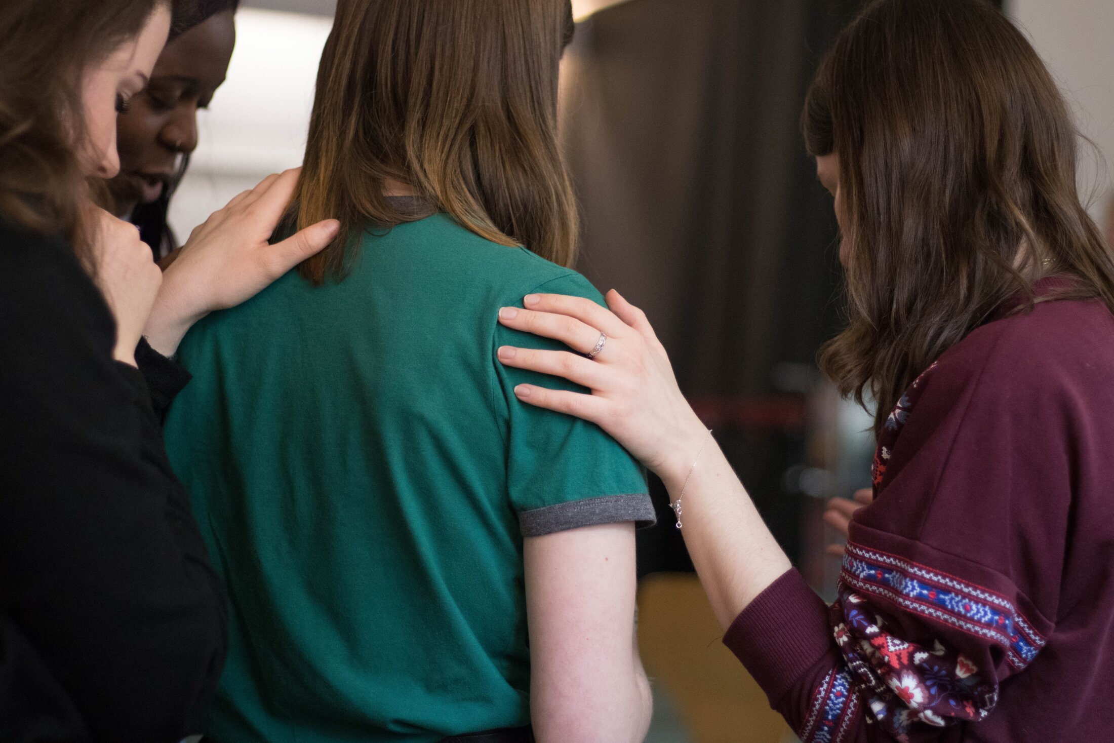 Stock image of a women putting her hand on someone's shoulder